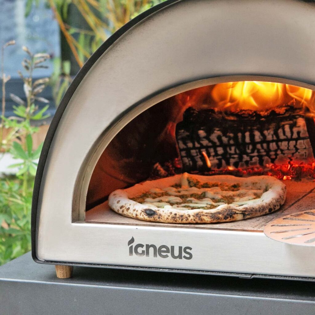 Igneus Classico wood fired pizza oven cooking garlic bread pizza